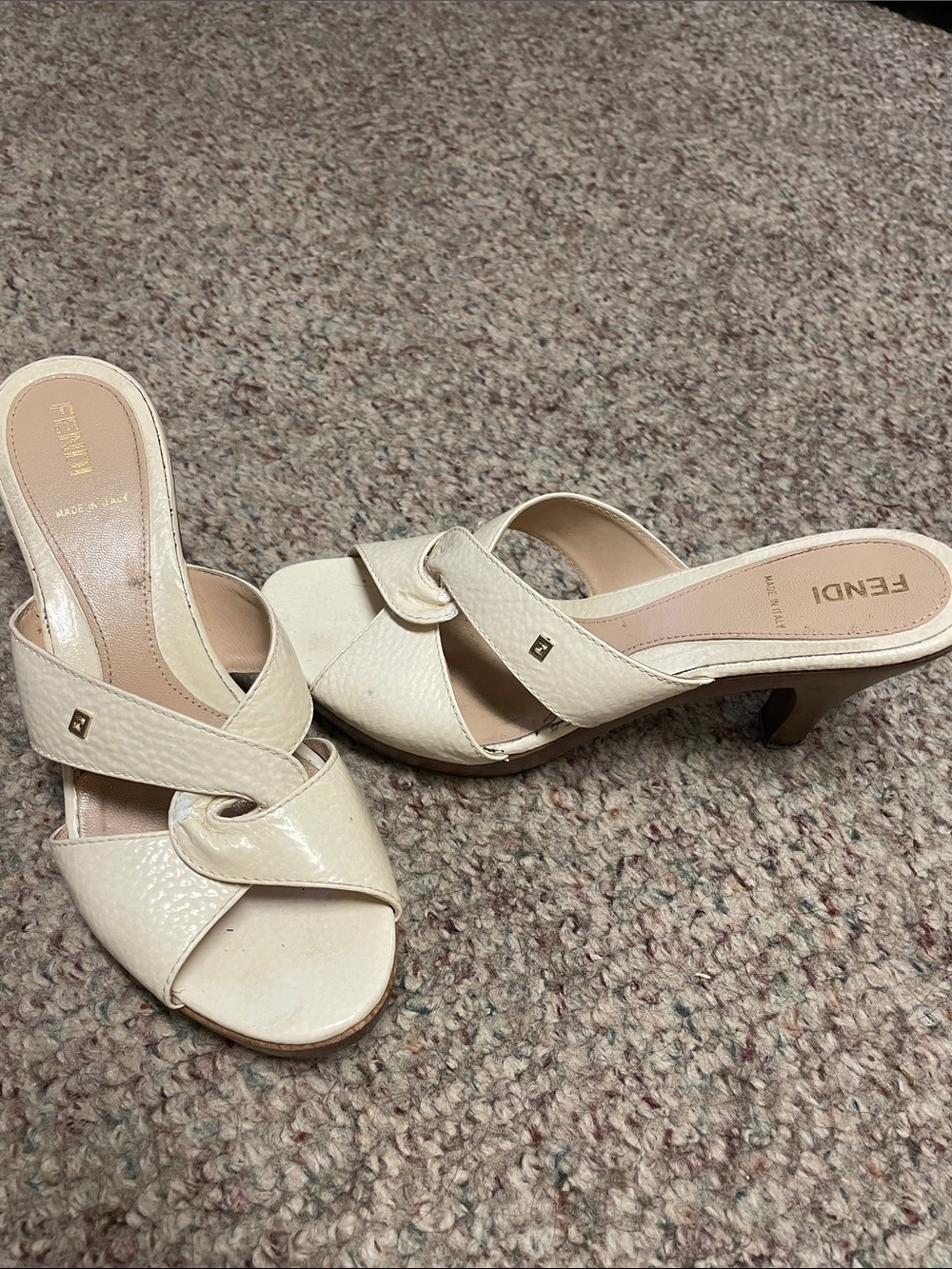 Fendi Cream Textured Leather Knot Slide Mules with gold logo accent